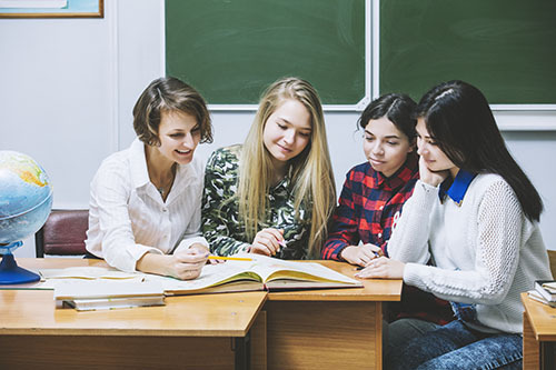 Teacher helping students